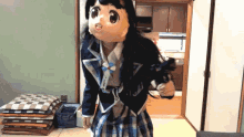 a girl in a doll costume stands in a room next to a stack of pillows