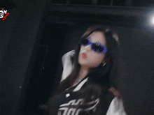 a woman wearing sunglasses and a shirt that says bic