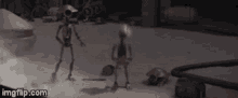 two robots are standing next to each other in a room with a turtle in the background .