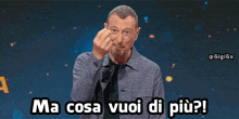 a man says ma cosa vuoi di più while making a fist