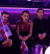 a group of people sitting on a couch holding flags one of which has a red cross on it