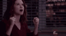 a woman with her fist in the air and the words grey 's anatomy grey sloan