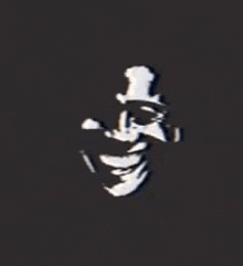 a black and white silhouette of a man wearing a top hat and sunglasses .
