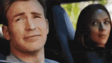 a man and a woman are sitting in a car .