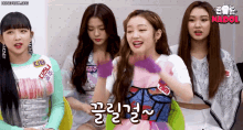 a group of young women are sitting next to each other and one of them has a name tag that says money