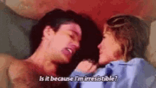 a man and a woman are laying on a bed and the man is asking the woman if it is because he is irresistible
