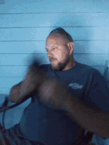 a man wearing a shirt that says chevrolet on the front