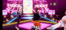 a group of people are dancing on a stage in a video game ..