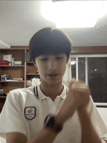 a young man wearing a white shirt with a patch that says ' supreme '