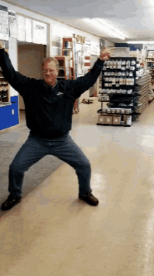 a man dancing in a store with his arms outstretched