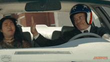a man wearing a helmet gives a woman a high five