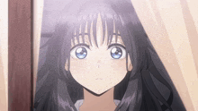a close up of a girl 's face with blue eyes