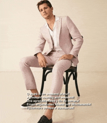 a man in a pink suit is sitting on a chair with the words o seara si on weekend placut