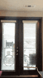 a door with blinds and a sign that says thank you on it