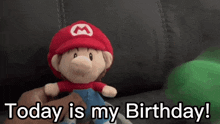 a stuffed mario doll is being held by someone and says today is my birthday