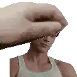 a man in a tank top is being slapped on the forehead by a large hand .