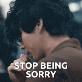 a picture of a man with the words stop being sorry behind him