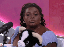 a woman holding a stuffed animal in front of a microphone with the hashtag #mexxxo16888 on the bottom