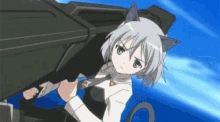 a girl with cat ears is holding a gun with a red star on it