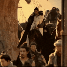 a group of people are riding horses in a crowded area