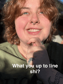 a woman with a tattoo on her arm is smiling with the words " what you up to line shi " above her