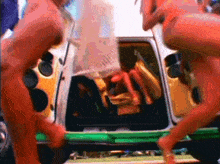 a man and a woman are standing next to a van