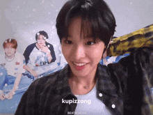 a girl is smiling in front of a poster that says kupizzang on it