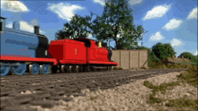 a red train has the number 5 on the side of it