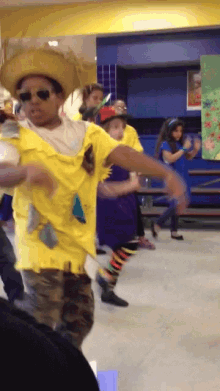a man in a cowboy hat is dancing with other children