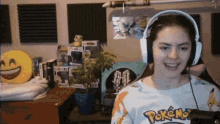 a woman wearing headphones and a shirt that says pokemon
