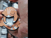 a close up of a person holding a cat shaped ornament