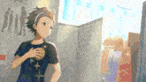 a boy in a black shirt with stars on it is standing in a room