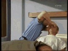 a man is laying in a hospital bed with tps written on the bottom of the screen