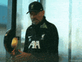 a man wearing a black sweater with the word axa on it
