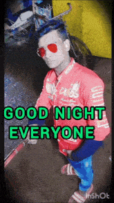 a man wearing sunglasses and a red shirt that says nike on it