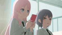 two anime girls are standing next to each other one holding a red book