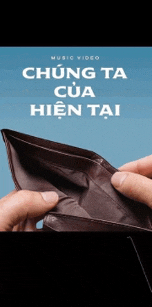 a person is holding an empty wallet with the words music video written on it