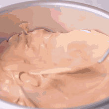 a silver cake pan filled with brown frosting with the words mr.cakes written on the bottom