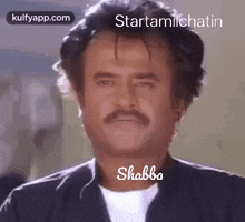 a man with a mustache is looking at the camera with the words starttamilchatin written on the bottom