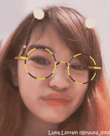 a woman wearing glasses has the name luna lorraine written below her
