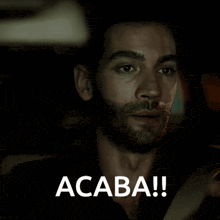 a man with a beard says acaba in white letters