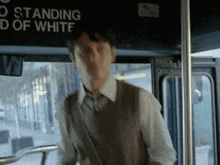 a man is standing in front of a sign that says " no standing "