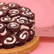 a cake with swirls on it is on a cutting board that says easy plus