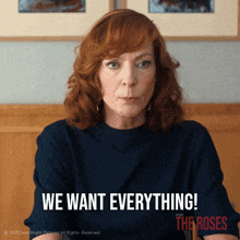 a woman with red hair says " we want everything " in an advertisement for the roses