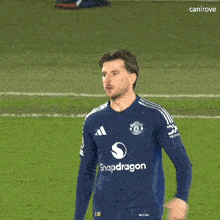 a soccer player wearing a blue shirt that says snapdragon on it