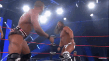 two men in a wrestling ring with a subscribe button on the bottom right