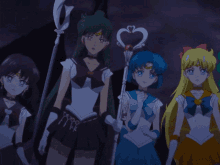 a group of anime characters are standing next to each other with one holding a heart shaped wand