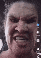 a close up of a woman 's face with like dislike and share icons visible