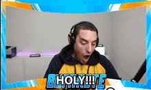 a man wearing headphones with the word holy written in blue