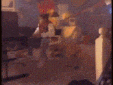 a blurry picture of a living room with a lamp and a computer monitor